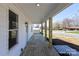 Covered front porch with wood decking, and wooden support columns, offering a relaxing outdoor space at 1018 Union St, Maiden, NC 28650