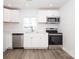 Bright kitchen features stainless appliances, white cabinets, subway tile backsplash, and wood grain flooring at 1018 Union St, Maiden, NC 28650