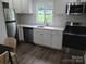 Modern kitchen boasts stainless steel appliances, white cabinetry, and stylish backsplash at 1018 Union St, Maiden, NC 28650