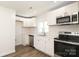 Bright kitchen features stainless appliances, white cabinets, subway tile backsplash, and wood grain flooring at 1018 Union St, Maiden, NC 28650