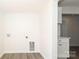 Laundry room with wood flooring, storage cabinets, and washer/dryer hookups at 1018 Union St, Maiden, NC 28650