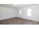 Bright living room features laminate flooring, a window, a door, and a modern ceiling light at 1018 Union St, Maiden, NC 28650