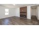 Living room featuring laminate floors, a modern fireplace, and an open view towards a hallway at 1018 Union St, Maiden, NC 28650