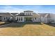 Exterior rear view of home showcasing the spacious backyard, windows and covered patio at 1132 Meander Ln, Waxhaw, NC 28173