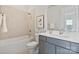 Clean, bright bathroom with a tub-shower, white tile, and gray vanity with a light countertop at 1132 Meander Ln, Waxhaw, NC 28173