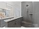 Elegant bathroom featuring gray tiled shower and sleek countertops with double vanity at 1132 Meander Ln, Waxhaw, NC 28173