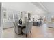 Open-concept dining room and kitchen with white cabinets and a center island with seating at 1132 Meander Ln, Waxhaw, NC 28173