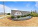 Landscaped community entrance sign with stone base and colorful flower bed at 1132 Meander Ln, Waxhaw, NC 28173