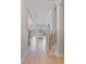 Open hallway with hardwood floors, leading to a bright living area with lots of windows and natural light at 1132 Meander Ln, Waxhaw, NC 28173