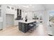 Modern kitchen with a large island, white cabinets, and stainless steel appliances at 1132 Meander Ln, Waxhaw, NC 28173