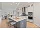 Spacious kitchen with an island featuring white countertops, stainless steel appliances, and a range hood at 1132 Meander Ln, Waxhaw, NC 28173