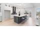 Bright kitchen with white cabinets, quartz countertops, stainless steel appliances, and a large island with seating at 1132 Meander Ln, Waxhaw, NC 28173