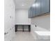 Functional laundry room with gray cabinets, a countertop, and ample storage space at 1132 Meander Ln, Waxhaw, NC 28173