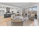 Bright, open-concept living room flows into a modern kitchen and features large windows with scenic views at 1132 Meander Ln, Waxhaw, NC 28173