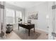 Bright office with a dark wood desk, modern decor, and natural light from two windows at 1132 Meander Ln, Waxhaw, NC 28173