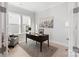 Well-lit home office featuring hardwood floors, large windows, city print art, and a comfortable seating area at 1132 Meander Ln, Waxhaw, NC 28173