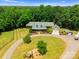 Aerial view showcases the extensive property with circular driveway, fire pit, and multiple outbuildings at 1363 John Cline Ct, Lincolnton, NC 28092