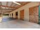 Stall area featuring multiple stalls with wood doors and concrete flooring under a metal roof at 1363 John Cline Ct, Lincolnton, NC 28092