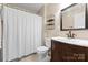 Well-lit bathroom features a classic vanity, and a shower with a white curtain at 1363 John Cline Ct, Lincolnton, NC 28092