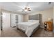 Cozy bedroom features soft carpet, a decorative ceiling fan, and ample closet space at 1363 John Cline Ct, Lincolnton, NC 28092