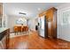 Bright dining area with hardwood floors, modern lighting, and stainless steel refrigerator at 1363 John Cline Ct, Lincolnton, NC 28092