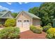 Two-car garage with carriage doors and manicured landscaping surrounding the building at 1363 John Cline Ct, Lincolnton, NC 28092