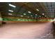 Large indoor equestrian arena with bright lighting and a smooth dirt surface at 1363 John Cline Ct, Lincolnton, NC 28092