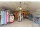 Inside view of garage with racks of clothes and lighting at 1363 John Cline Ct, Lincolnton, NC 28092