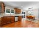 Charming kitchen featuring hardwood floors, stainless steel dishwasher, and a view to the dining area at 1363 John Cline Ct, Lincolnton, NC 28092