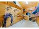 Organized tack room featuring saddle racks, shelving, and a small refrigerator at 1363 John Cline Ct, Lincolnton, NC 28092