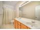 Bright bathroom featuring a double sink vanity and a shower with curtain at 1730 Sanridge Wind Ln, Charlotte, NC 28262