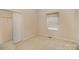 Simple bedroom with carpet, a closet, and window at 1730 Sanridge Wind Ln, Charlotte, NC 28262