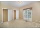 Well-lit bedroom with a window and a closet at 1730 Sanridge Wind Ln, Charlotte, NC 28262