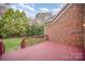 Wood deck overlooking the backyard with a brick exterior at 1730 Sanridge Wind Ln, Charlotte, NC 28262