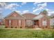 Charming brick home featuring a well-manicured lawn and inviting front entrance at 1730 Sanridge Wind Ln, Charlotte, NC 28262