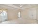 Spacious main bedroom with tray ceiling, carpet, and a double-door closet at 1730 Sanridge Wind Ln, Charlotte, NC 28262