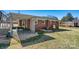 View of the backyard and back of the house featuring a covered patio and a well-maintained lawn at 1802 Young Dr, Conover, NC 28613