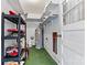 Basement with green floor and white walls, featuring shelving and storage at 1802 Young Dr, Conover, NC 28613