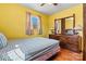 Bedroom with yellow walls, wood floors, and a classic mirror and dresser at 1802 Young Dr, Conover, NC 28613