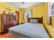 Cozy bedroom with yellow walls, wood floors, and classic furniture arrangement at 1802 Young Dr, Conover, NC 28613