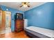 Cozy bedroom with blue walls, ceiling fan, and a wooden dresser with a television on top at 1802 Young Dr, Conover, NC 28613