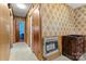 Hallway with wood paneling, floral wallpaper, and access to other rooms in the house at 1802 Young Dr, Conover, NC 28613