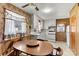 Eat-in kitchen featuring floral wallpaper, white appliances, and classic wood table with chairs at 1802 Young Dr, Conover, NC 28613