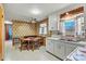 Cozy kitchen featuring retro wallpaper, white cabinets, and a dining area with wooden chairs at 1802 Young Dr, Conover, NC 28613