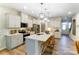 Well-lit kitchen featuring stainless steel appliances, white cabinetry, an island with bar seating, and hardwood floors at 212 Laura Elizabeth Ln, Clover, SC 29710