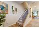 Carpeted staircase with wood railing and views into the kitchen, dining room and decor at 212 Laura Elizabeth Ln, Clover, SC 29710