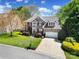 Beautiful brick home with a well-manicured lawn, lovely landscaping, and a two-car garage at 227 Coralstone Dr, Fort Mill, SC 29708