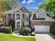Charming two-story brick home featuring a well-manicured lawn and a welcoming front porch at 227 Coralstone Dr, Fort Mill, SC 29708