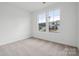 Well-lit bedroom with neutral carpet, large windows, and ample space for furniture at 2577 Blue Sky Meadows Dr, Monroe, NC 28110