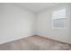 Comfortable bedroom with neutral carpet, window providing natural light, and calming ambiance at 2577 Blue Sky Meadows Dr, Monroe, NC 28110